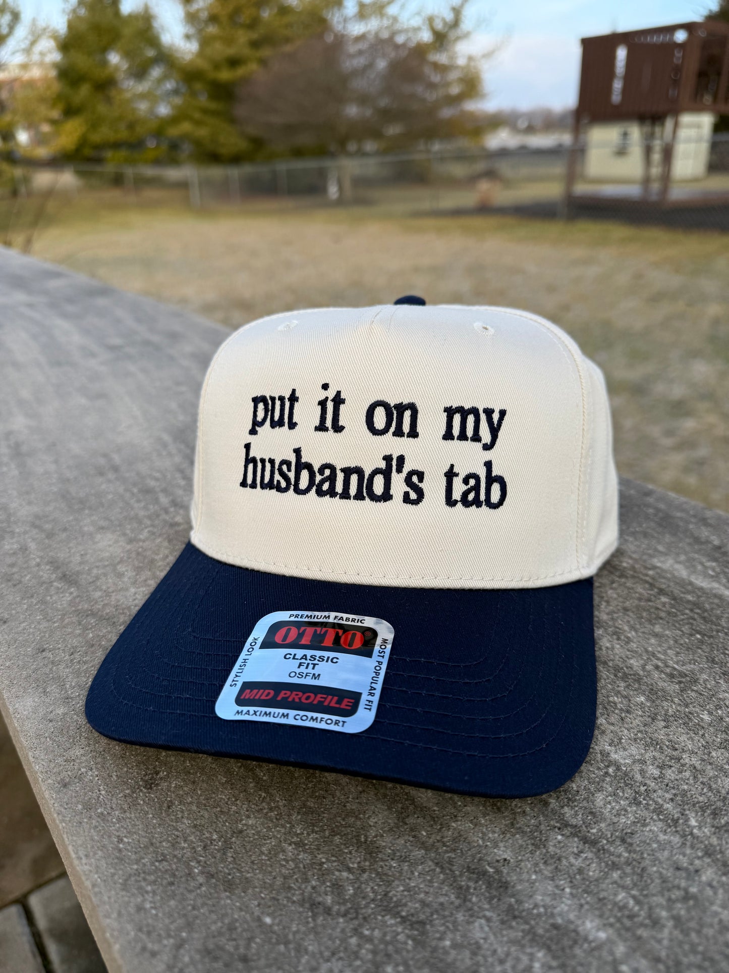 Put It On My Husband's Tab Trucker Hat