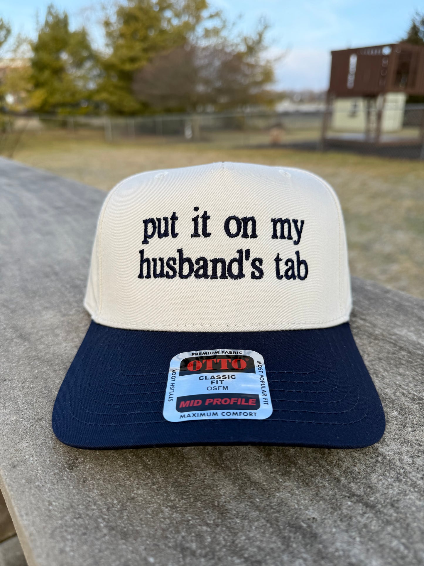 Put It On My Husband's Tab Trucker Hat